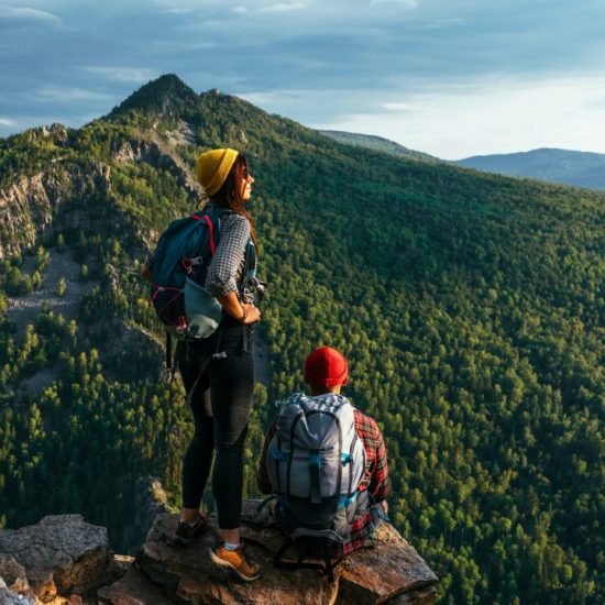 a-man-and-a-woman-with-backpacks-on-the-mountain-admire-the-panoramic-view-hiking.jpg