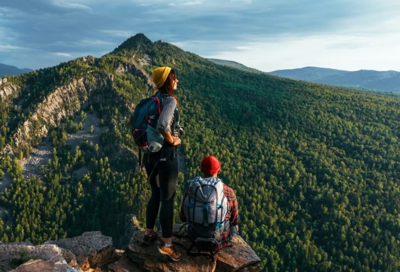 a-man-and-a-woman-with-backpacks-on-the-mountain-admire-the-panoramic-view-hiking.jpg