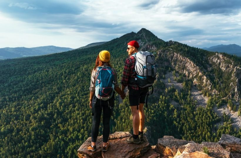 two-tourists-on-the-top-of-the-mountain-a-man-and-a-woman-in-the-mountains.jpg